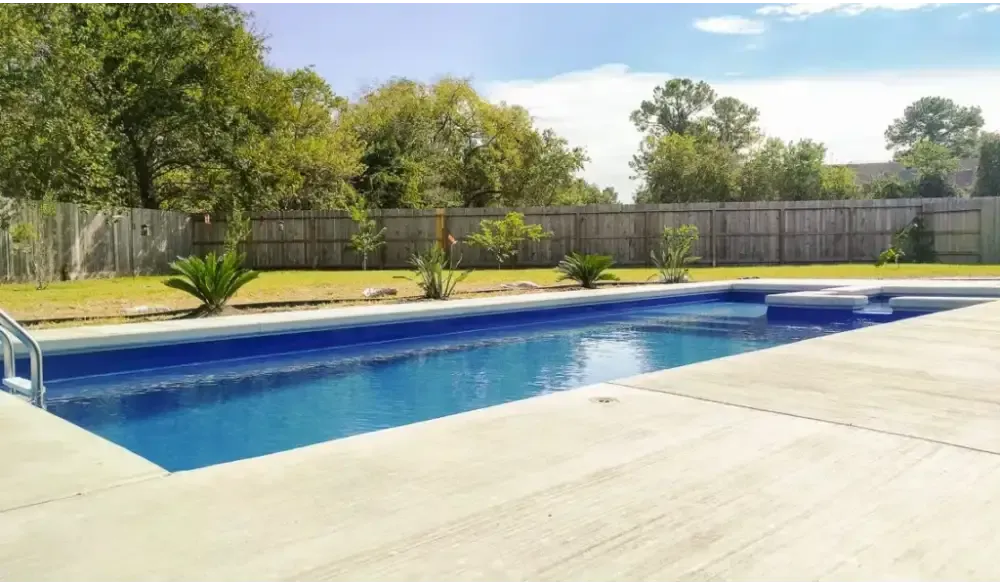 Leisurepools Limitless pool – modern design, rectangular shape, clear blue water, concrete deck, for limited space