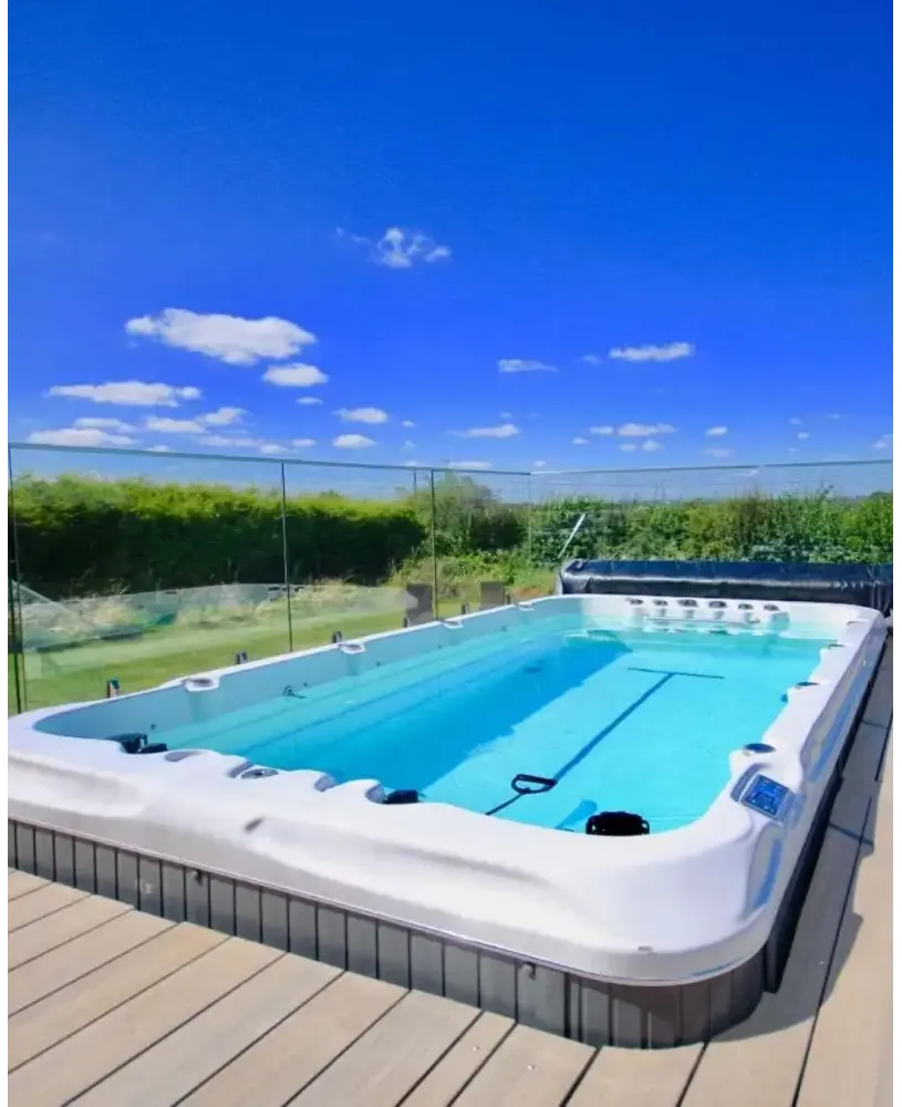 PassionSpa Fitness 1 swim spa – white finish, rectangular shape, blue water, grey tiled base