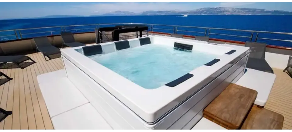 PassionSpa Serene 6 Fire Pit hot tub – white finish, rectangular shape, black panels, clear blue water, wooden deck