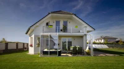 Modern white two-storey villa – tiled roof and glass balcony