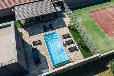 Aruba fibreglass pool – blue finish, rectangular shape, tiled edges, ripples in the water