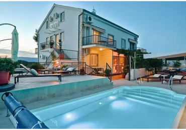 Aves fibreglass pool – modern design, rounded steps, tiled pool surround, beside a villa