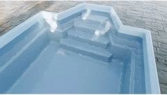 Grenada fibreglass pool – distinctive shape, comfortable seating, light blue finish