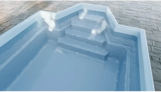 Grenada fibreglass pool – distinctive shape, comfortable seating, light blue finish