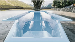 Grenada fibreglass pool – distinctive shape, comfortable seating, modern design, light blue water