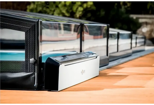 Solar-powered Moover electric motor for a black-and-white pool cover assistance device