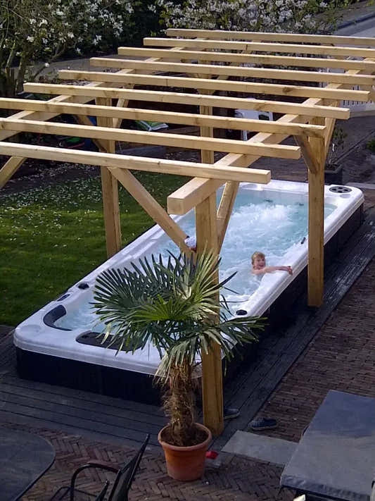 PassionSpa Aquatic 2 swim spa – white and black, bubbling water, pergola