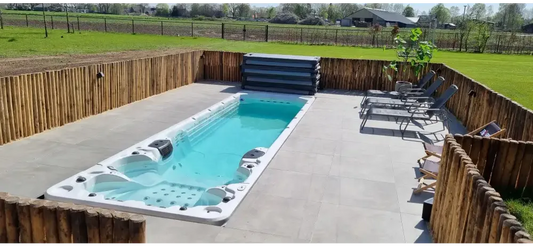 PassionSpa Aquatic 6 swim spa – Sport Collection, white finish, rectangular shape, turquoise water, black massage jets, wooden fence