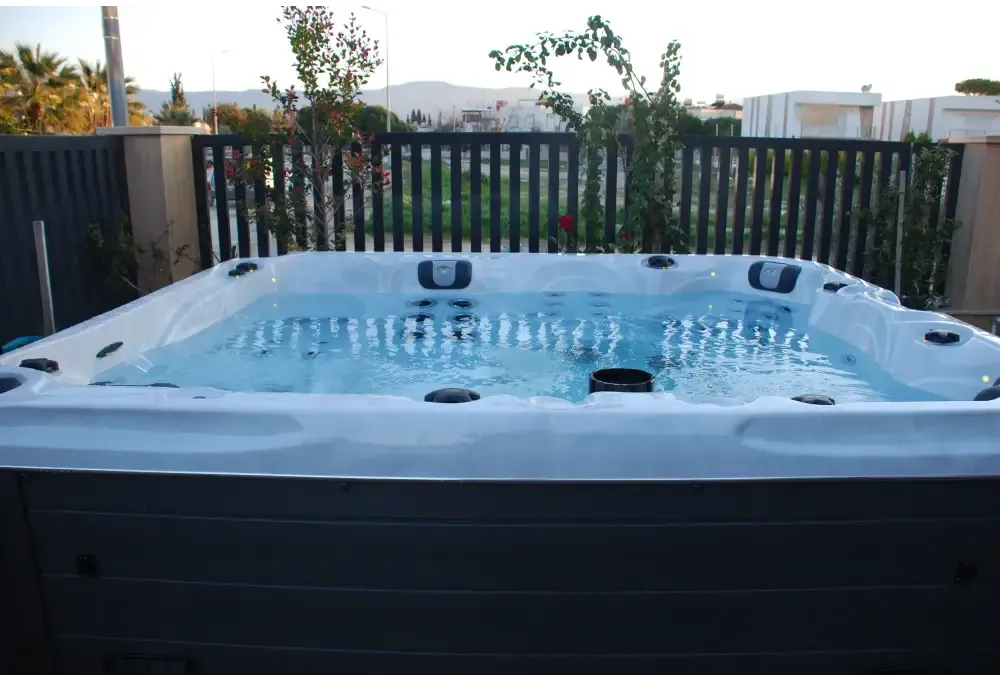PassionSpa Desire hot tub – white and grey, blue water, black massage jets