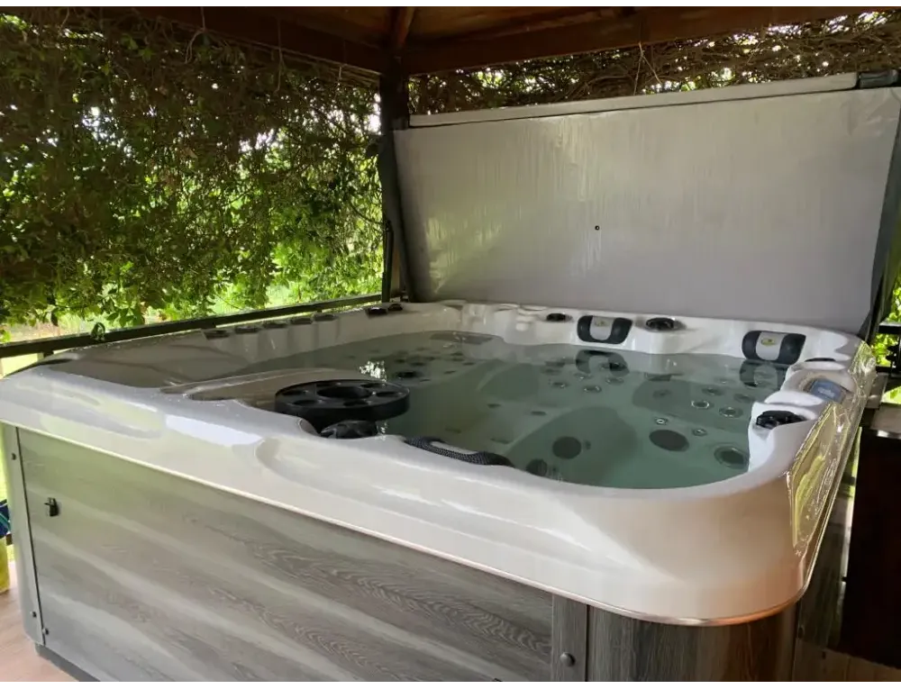 PassionSpa Euphoria Mighty Wave hot tub – white finish, white interior, grey wood panels, black massage jets