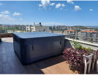 PassionSpa Euphoria Mighty Wave hot tub – dark grey finish, cover, on a roof terrace