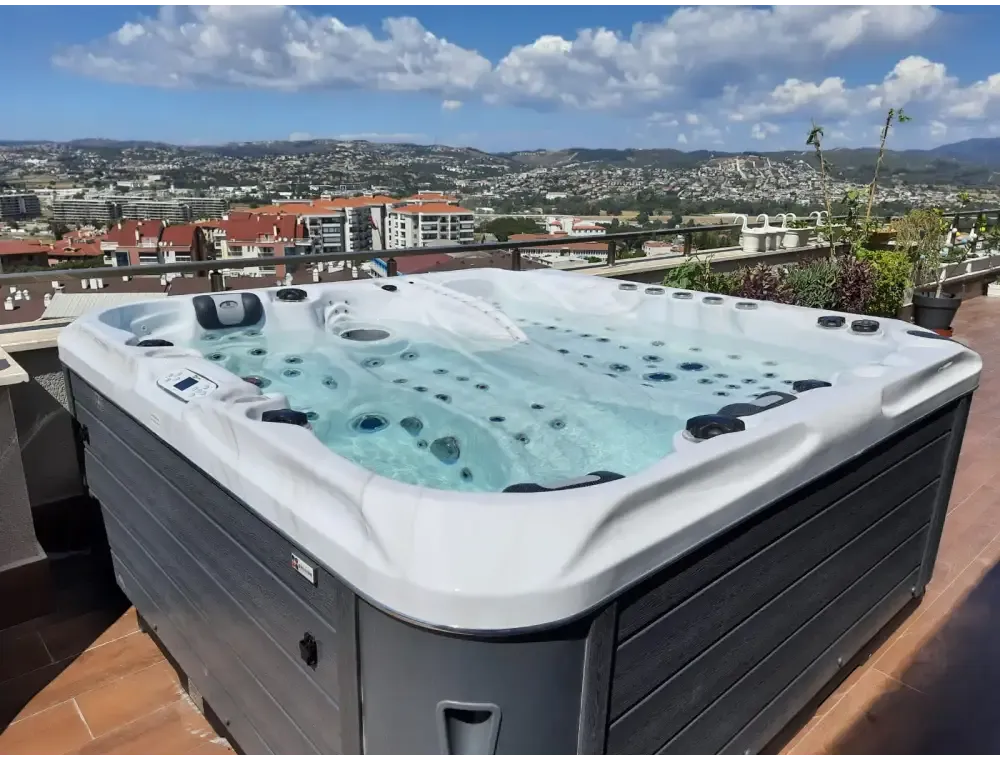 PassionSpa Euphoria Mighty Wave hot tub – white and grey, black massage jets, clear blue water