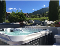 PassionSpa Euphoria Mighty Wave hot tub – silver and black, massage jets, in the garden