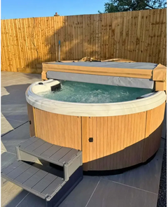 PassionSpa Recharge hot tub – wooden panel, grey fabric cover, matching steps