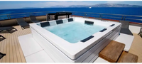 PassionSpa Serene 6 Fire Pit hot tub – white finish, rectangular shape, black panels, clear blue water, wooden deck