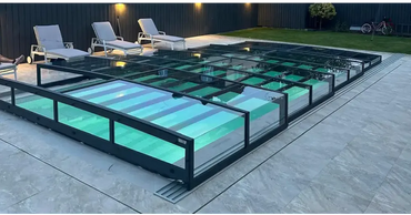 Icon Kit pool enclosure – modern design, transparent enclosure, indoors, black frame, turquoise water, illuminated pool area