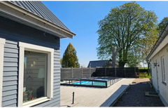 Icon Kit pool enclosure – modern design, blue metal roof with white trim