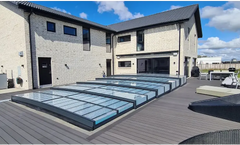 Icon Kit pool enclosure – modern transparent panel design, dark frames, over a wooden deck