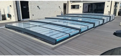 Icon Kit pool enclosure – modern transparent panel design, black frame, over a wooden deck