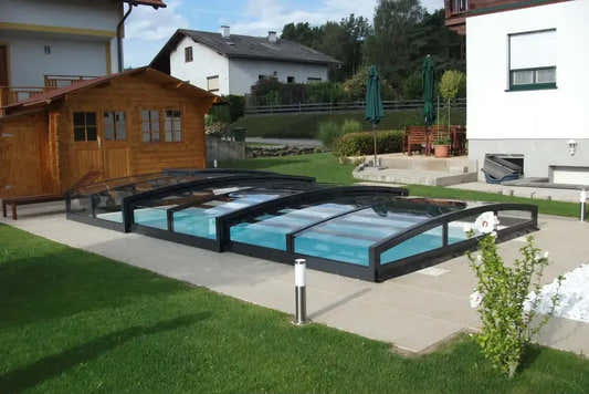 Special pool enclosure – black frame, curved clear panels, for a pool