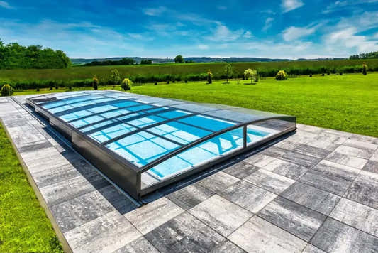 Ultra-low Sydney 4 x 7 pool enclosure – blue-tinted panels, metal frame