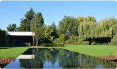 Above-ground PP pool in 20 mm material with a skimmer – modern design, white finish, infinity edge, green trees