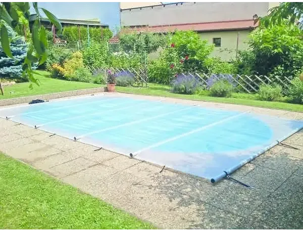 Blue pool cover including a manual operating unit – lawn, garden pool